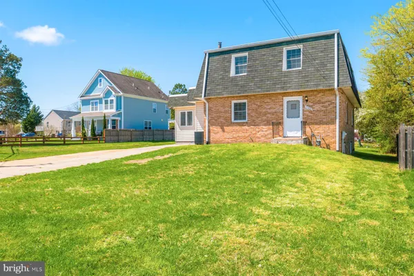 a front view of a house with a yard and porch