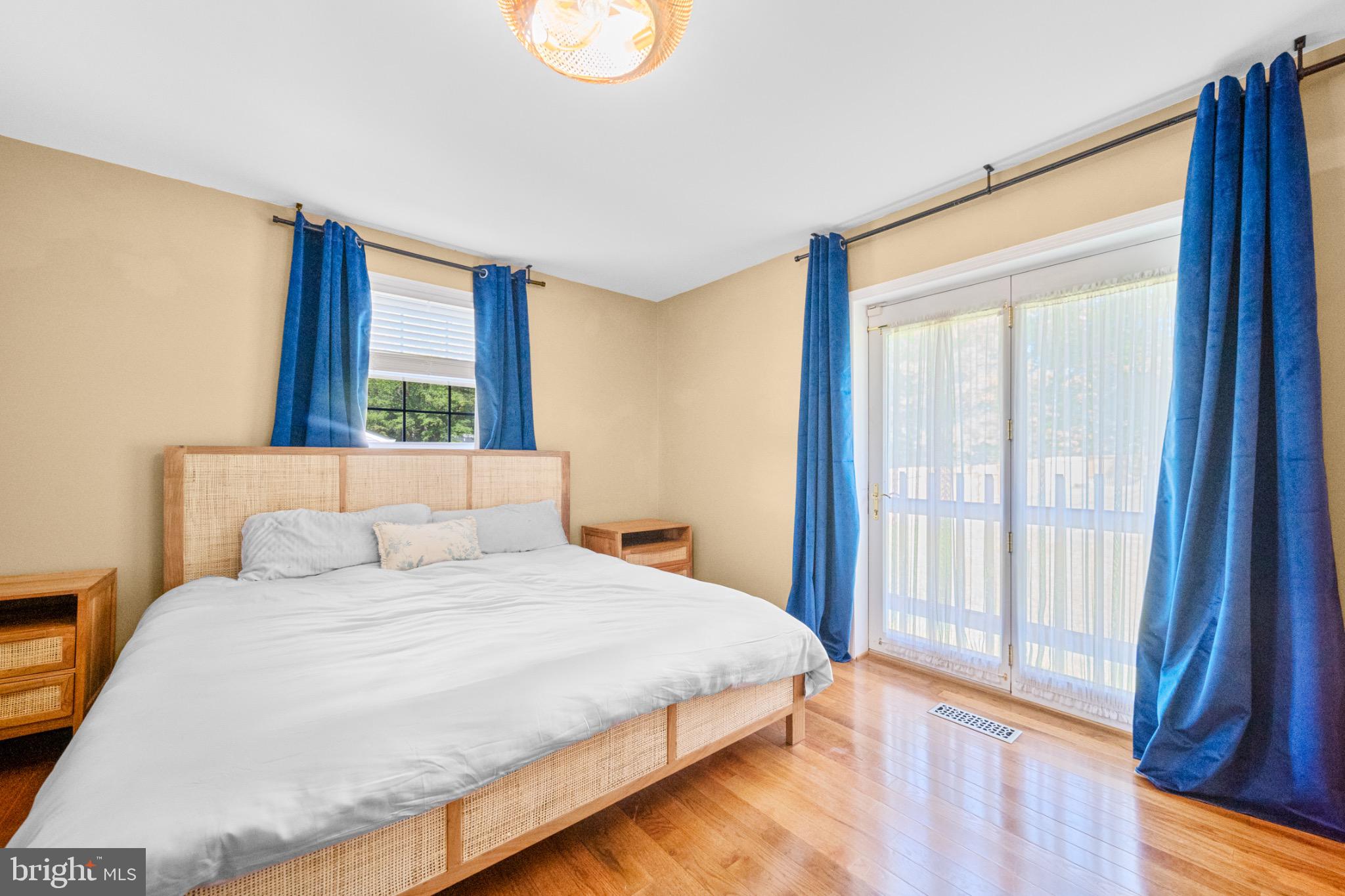 16508 Rolling Tree Road Accokeek, MD 20607 - Photo 19 of 62 a bedroom with a large bed and a large window
