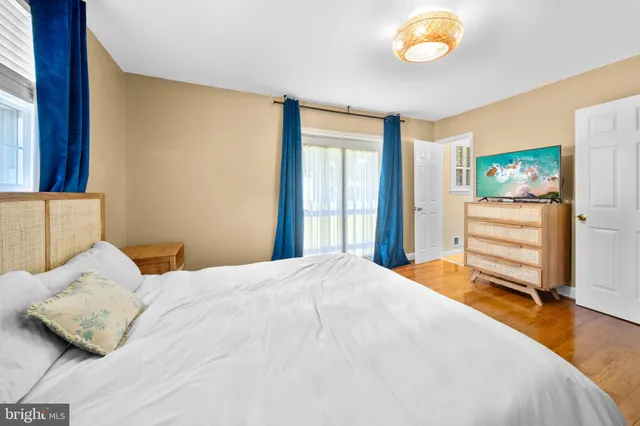 a bathroom with a granite countertop sink a toilet a mirror and a shower