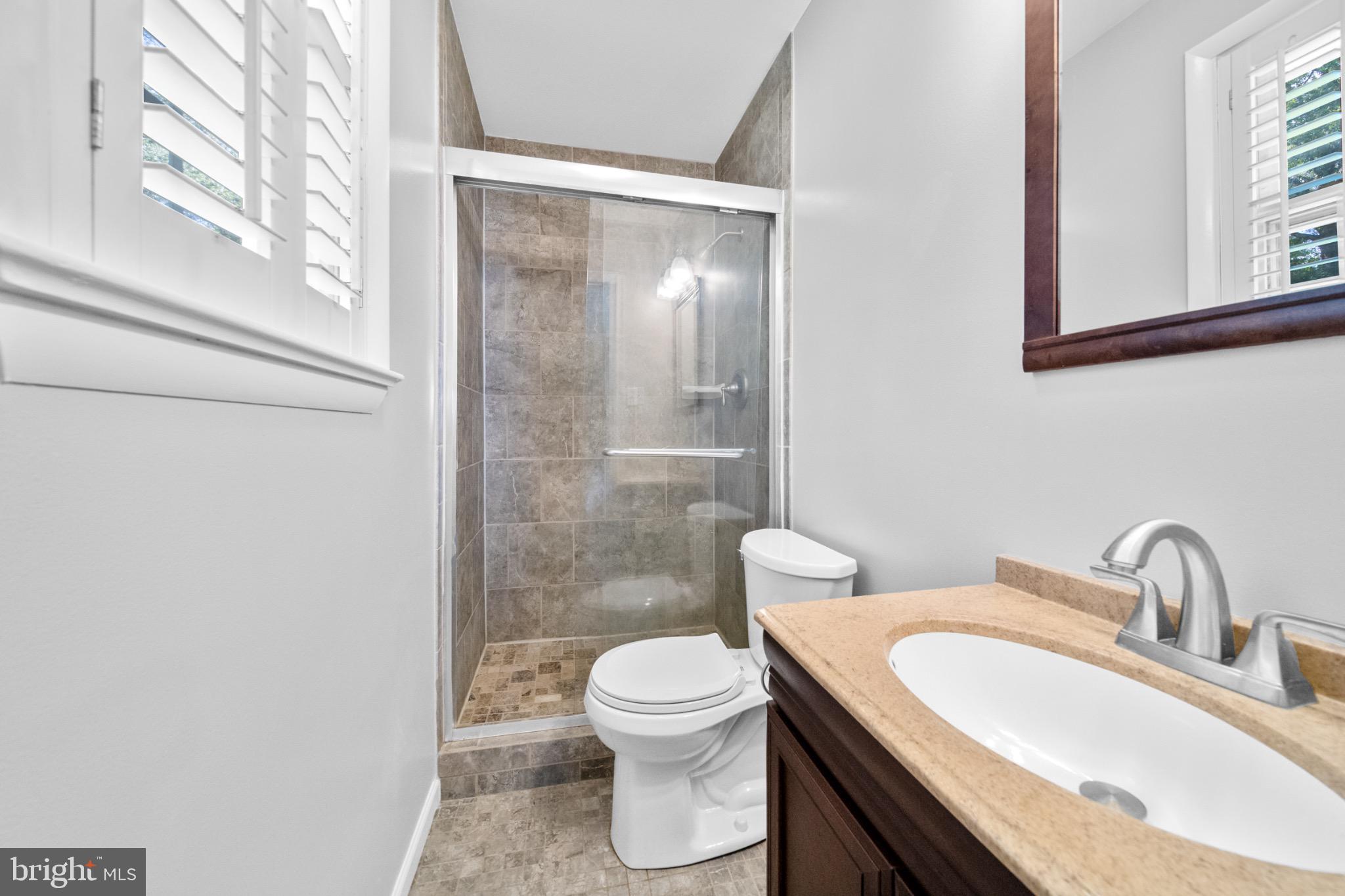 16508 Rolling Tree Road Accokeek, MD 20607 - Photo 23 of 62 a bathroom with a toilet a sink and a window