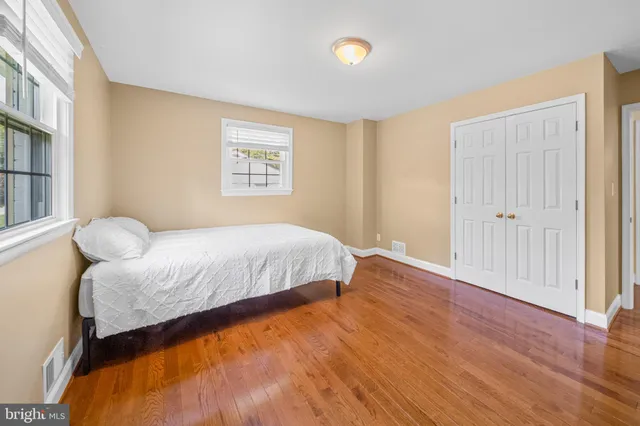 a room with a bed and wooden floor