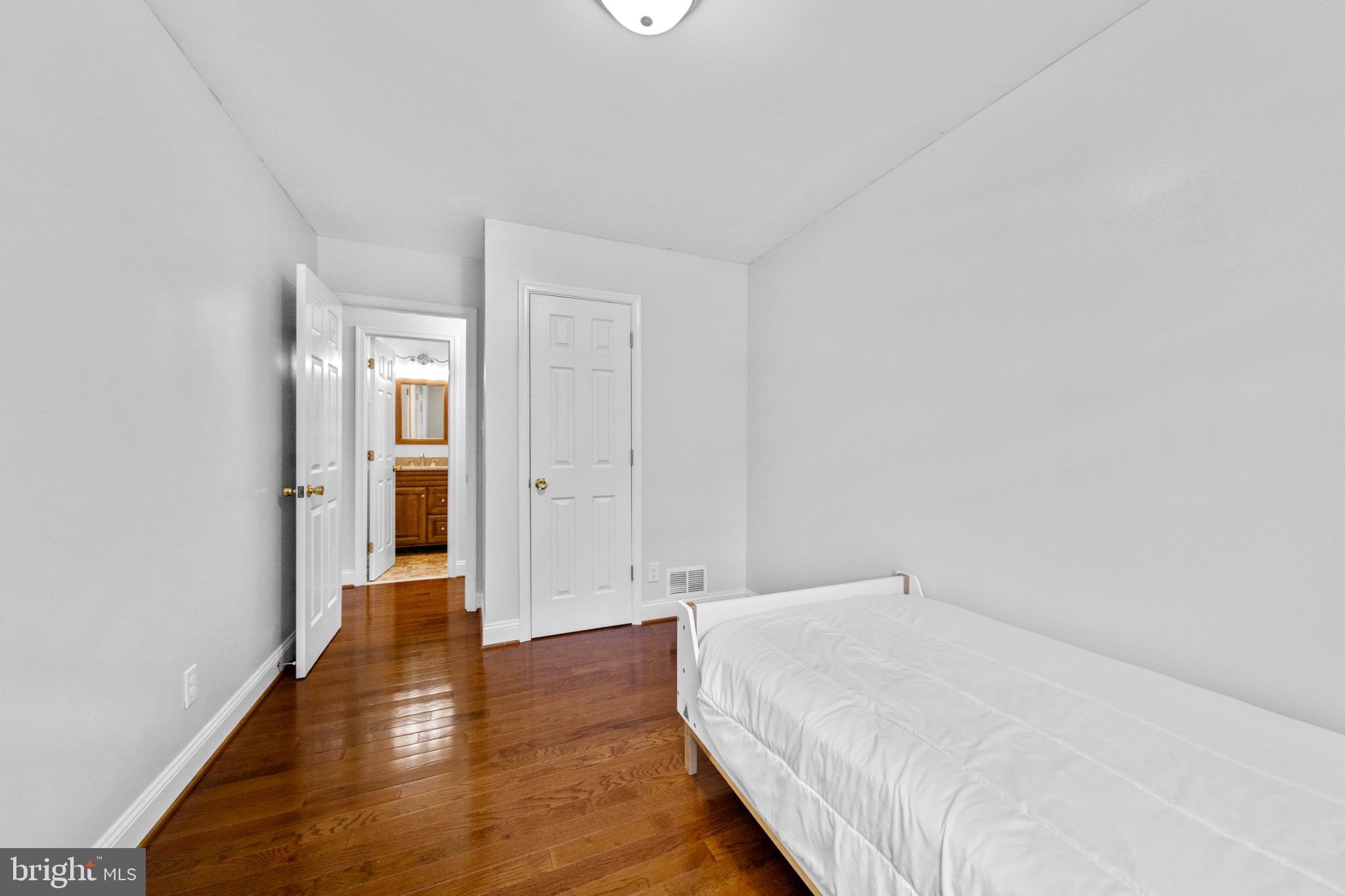 16508 Rolling Tree Road Accokeek, MD 20607 - Photo 28 of 62 a room with a bed and wooden floor