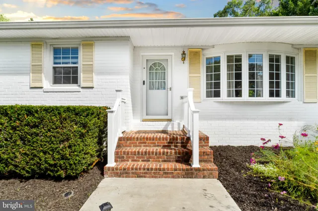 a kitchen with granite countertop white cabinets and a stove top oven
