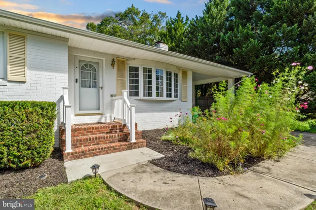 a kitchen with granite countertop white cabinets and stainless steel appliances