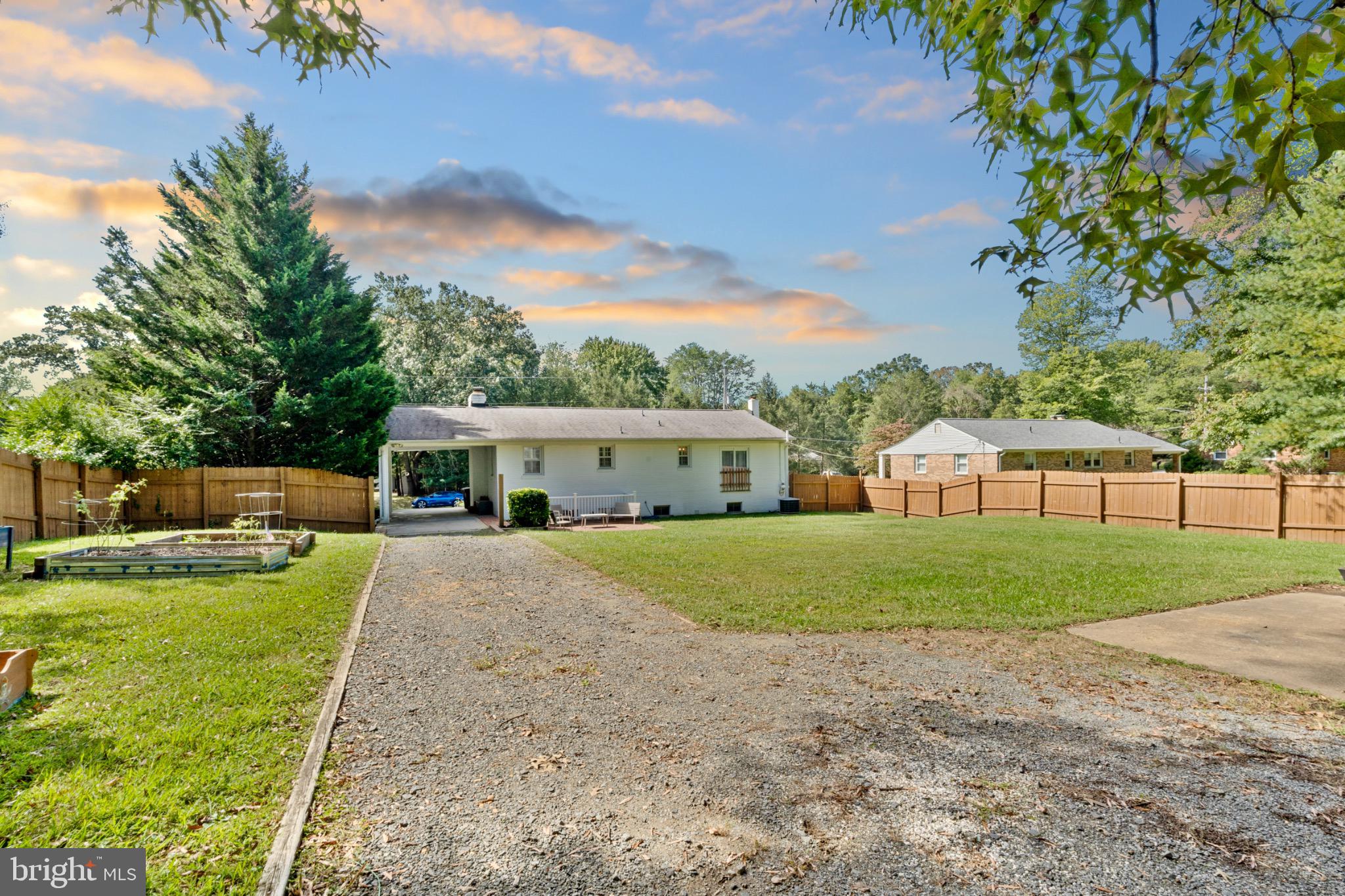 16508 Rolling Tree Road Accokeek, MD 20607 - Photo 48 of 62 a front view of a house with a garden and trees