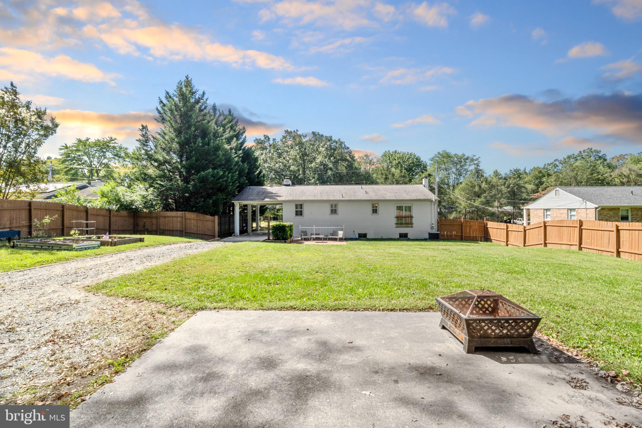 16508 Rolling Tree Road Accokeek, MD 20607 - Photo 49 of 62 a front view of a house with a garden and trees