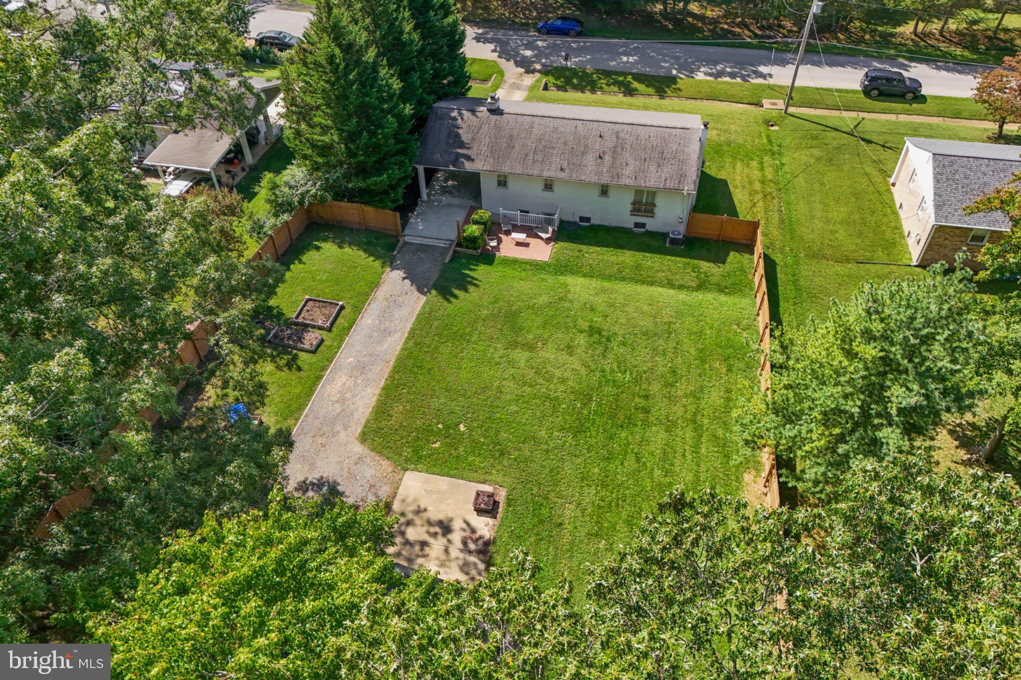 16508 Rolling Tree Road Accokeek, MD 20607 - Photo 55 of 62 an aerial view of a house with a garden and swimming pool