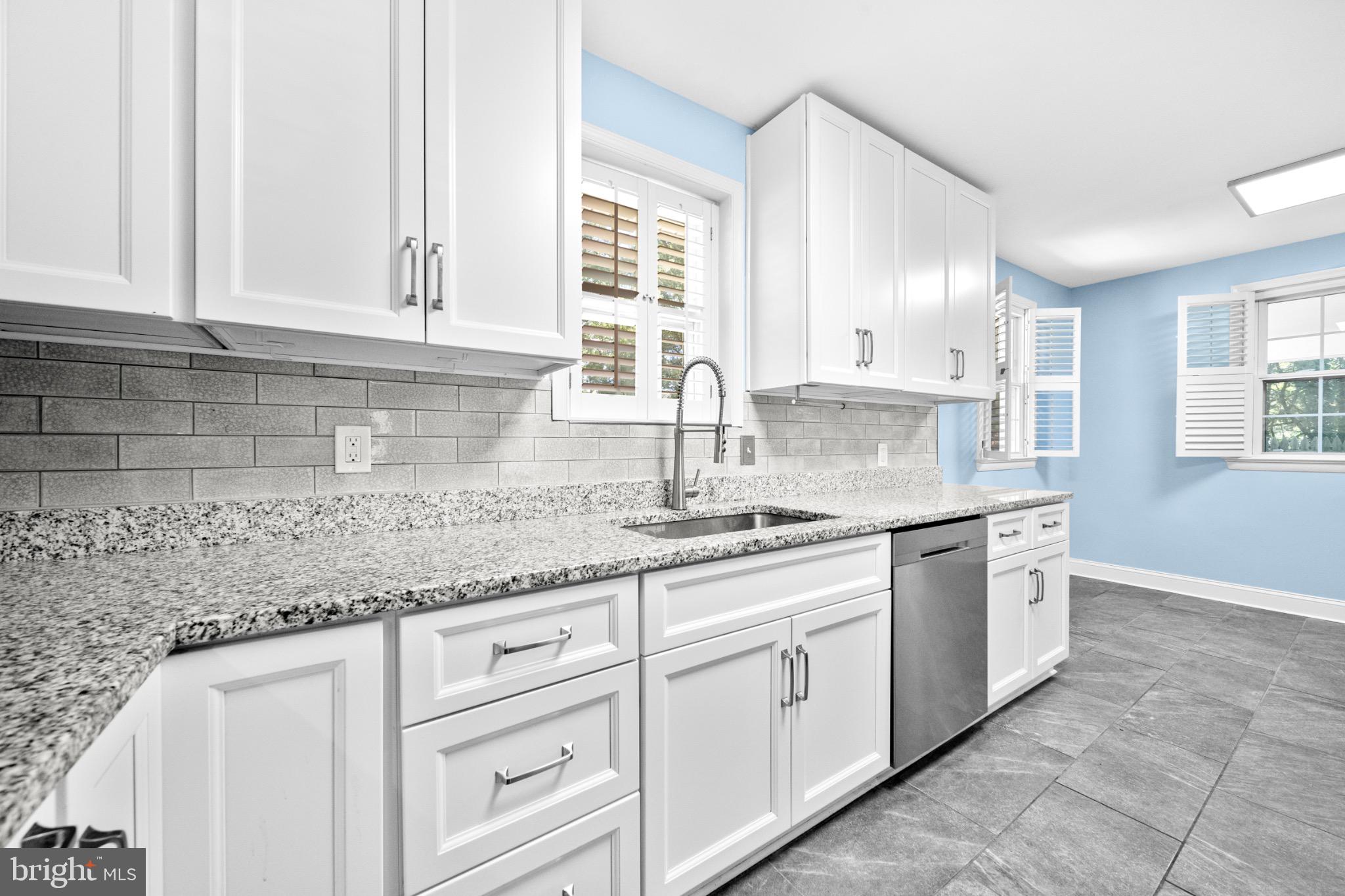 16508 Rolling Tree Road Accokeek, MD 20607 - Photo 9 of 62 a kitchen with granite countertop white cabinets white appliances and a sink