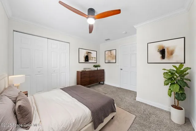 a bedroom with a bed and a potted plant