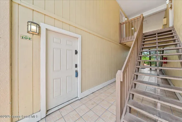 a view of staircase with wooden floor and windows