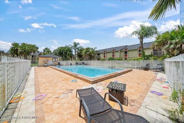a view of a swimming pool with a lounge chairs