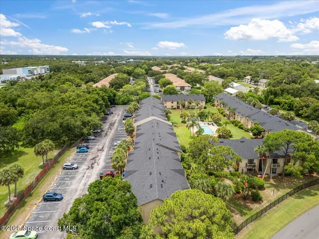 an aerial view of residential houses with outdoor space