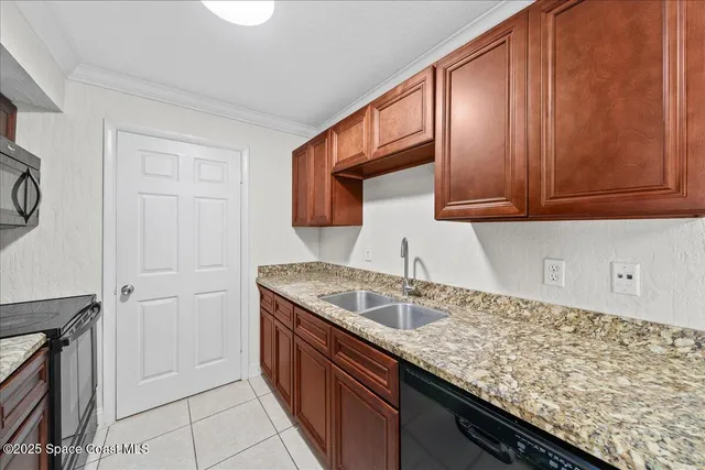 a kitchen with granite countertop a sink and cabinets
