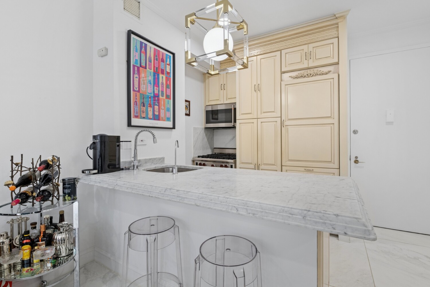 530 East 76th Street, Unit 6J Manhattan, NY 10021 - Photo 5 of 10 a kitchen with cabinets a center island and stainless steel appliances