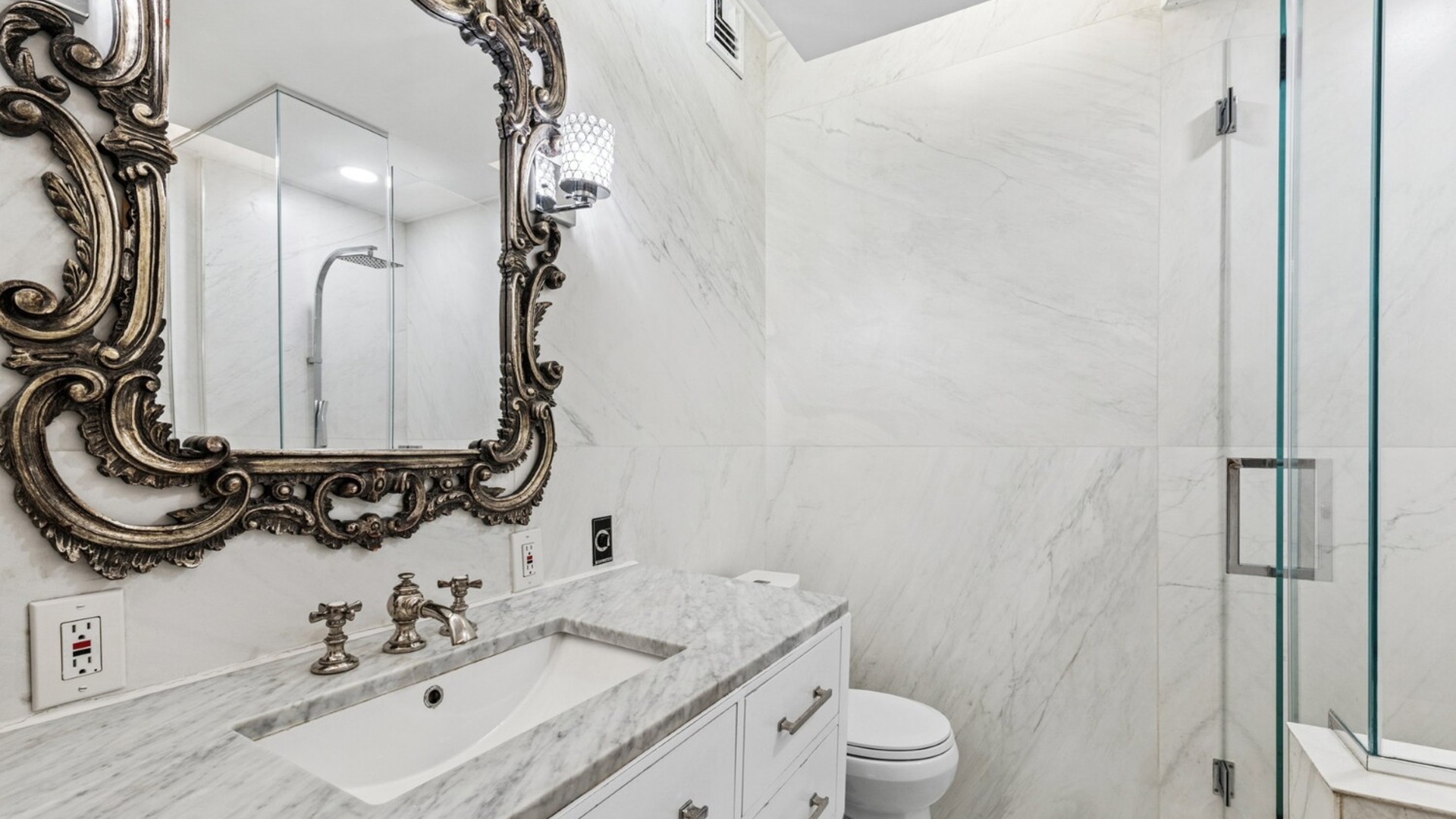 530 East 76th Street, Unit 6J Manhattan, NY 10021 - Photo 7 of 12 a bathroom with a granite countertop sink a toilet and a mirror