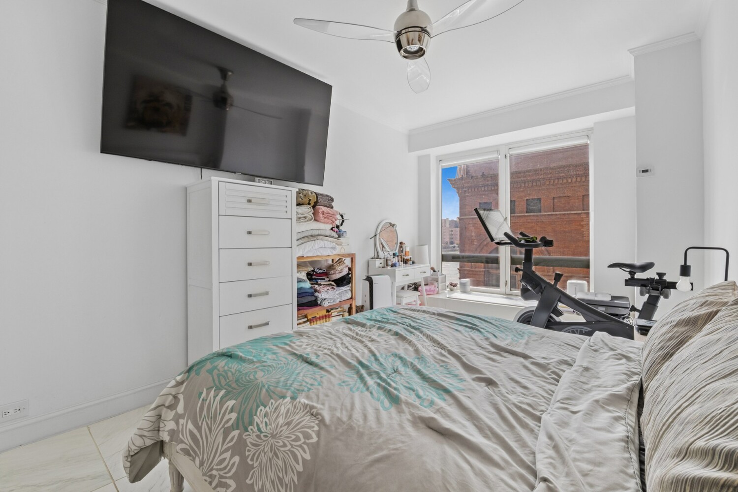 530 East 76th Street, Unit 6J Manhattan, NY 10021 - Photo 6 of 10 a bed room with a bed and a television
