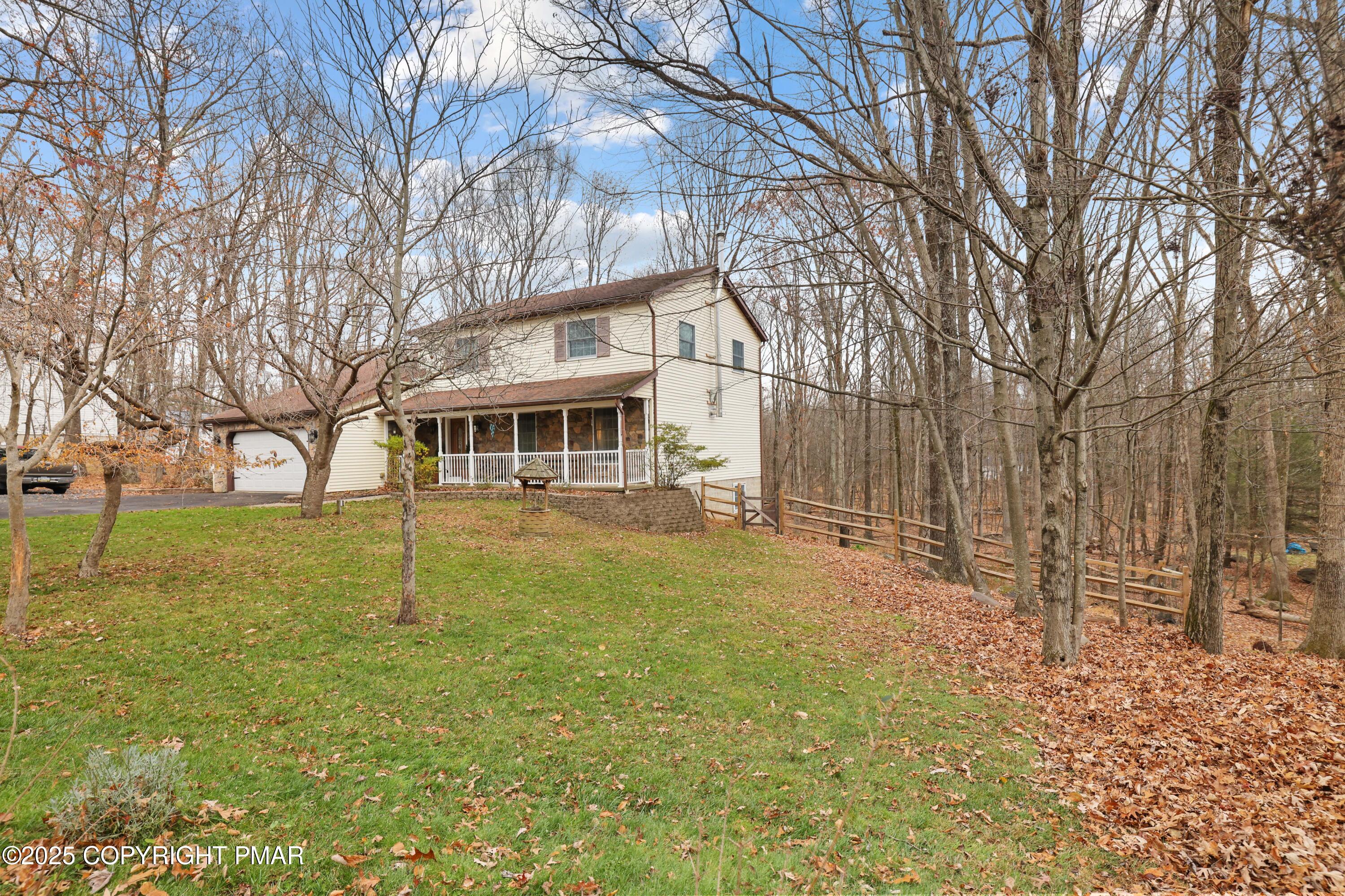 113 Hemlock Road Tannersville, PA 18372 - Photo 1 of 68 a view of a yard in front of a house with a large tree