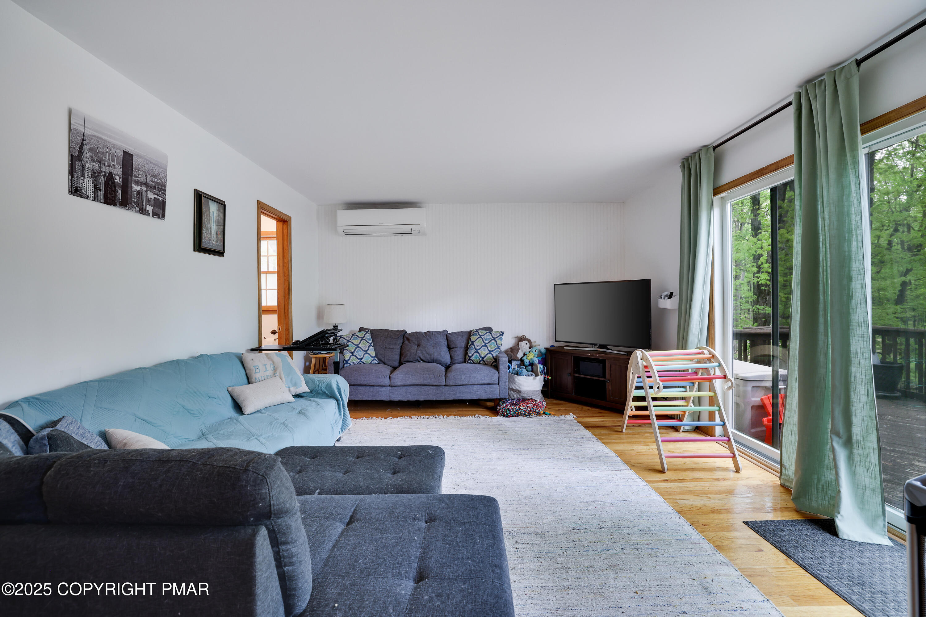 113 Hemlock Road Tannersville, PA 18372 - Photo 24 of 68 a living room with furniture and a flat screen tv