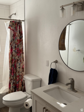 496 North 300 West Mapleton, UT 84664 - Photo 22 of 49 Modern bathroom featuring a sleek circular mirror with matte black frame, white vanity with integrated rectangular sink, polished chrome faucet, and tile flooring throughout