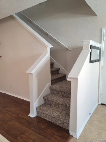 a view of entryway and hall with wooden floor