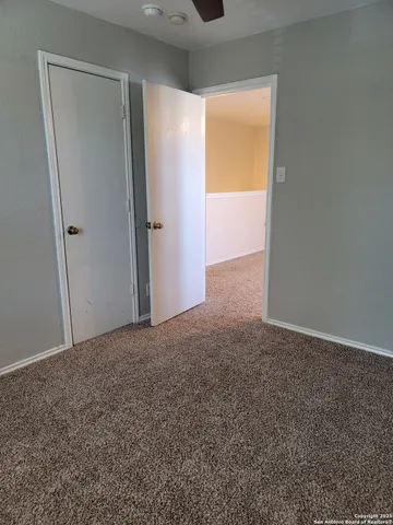 a view of an empty room and a window