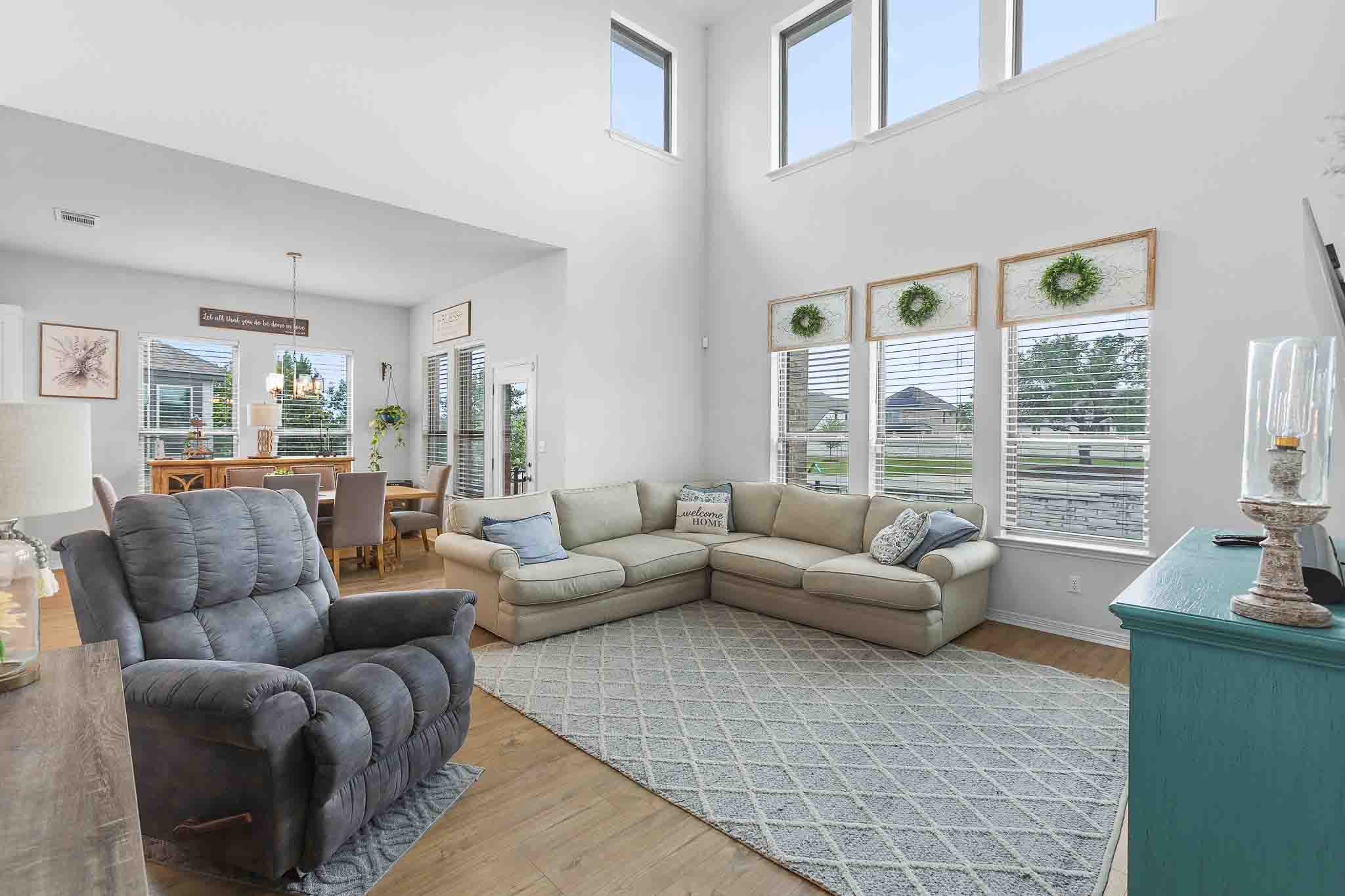 166 West Branch Road Kyle, TX 78640 - Photo 13 of 39 A spacious living area with soaring ceilings and abundant natural light from tall windows.