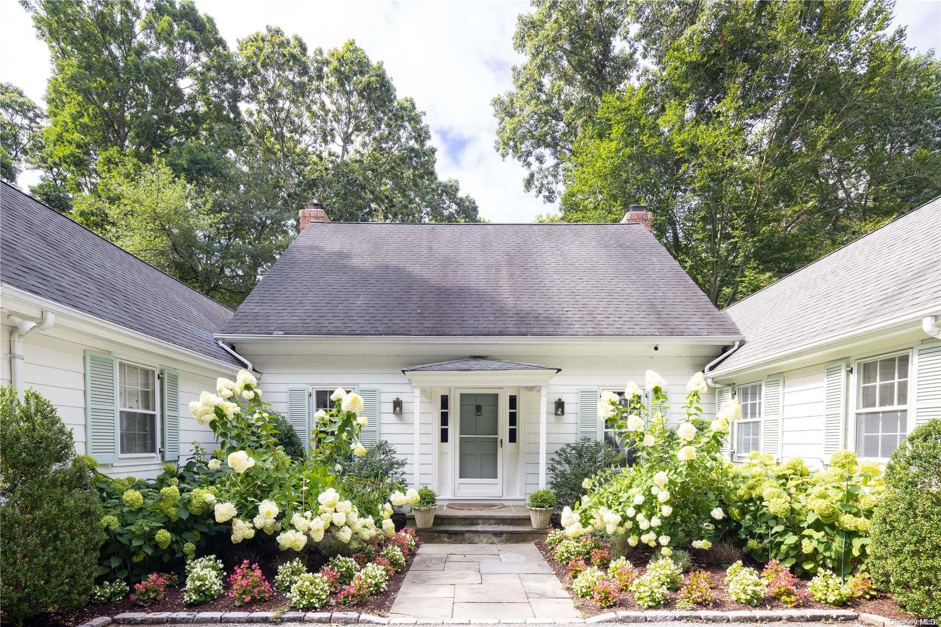 271 Piping Rock Road Glen Head, NY 11545 - Photo 1 of 1 front view of house with potted plant of flower