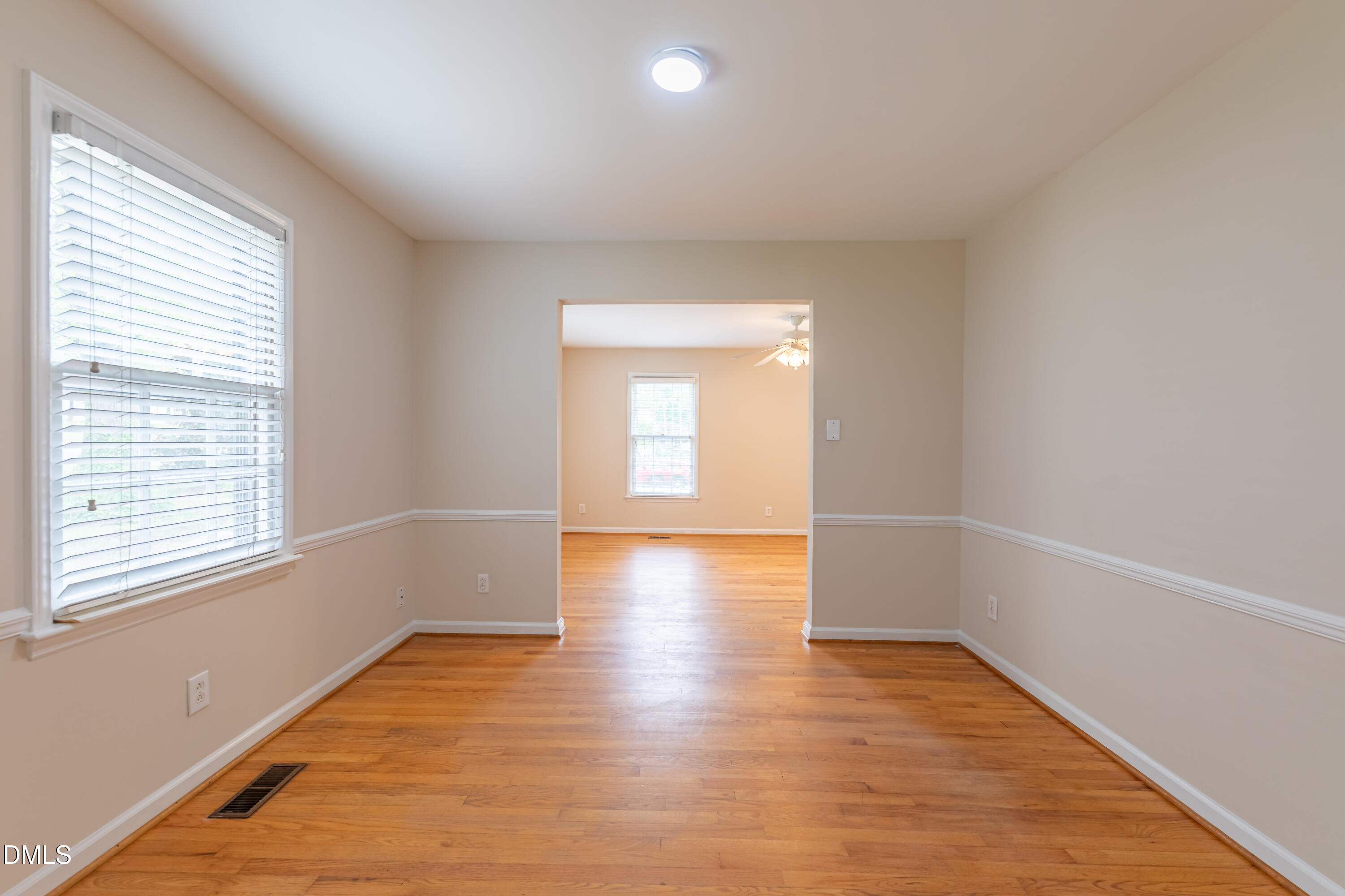 408 Ortega Road Raleigh, NC 27609 - Photo 4 of 25 wooden floor in an empty room with a window