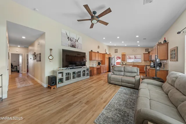 a kitchen with stainless steel appliances granite countertop a table chairs sink and cabinets