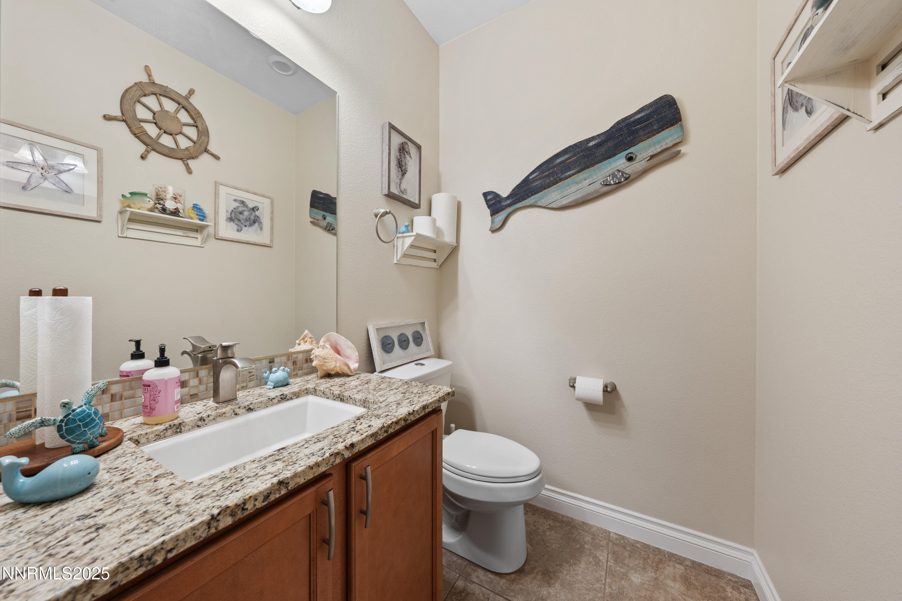 18520 Silverbell Court Reno, NV 89508 - Photo 27 of 60 a bathroom with a granite countertop sink a toilet and a mirror