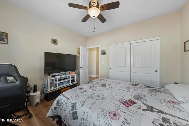 a view of room with wooden floor and ceiling fan