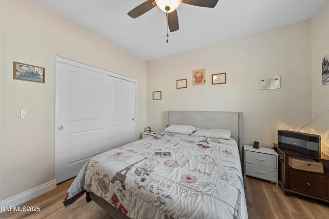 a bathroom with a granite countertop double vanity sink and a mirror