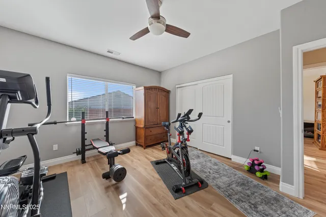 a living room with furniture a flat screen tv and a large window