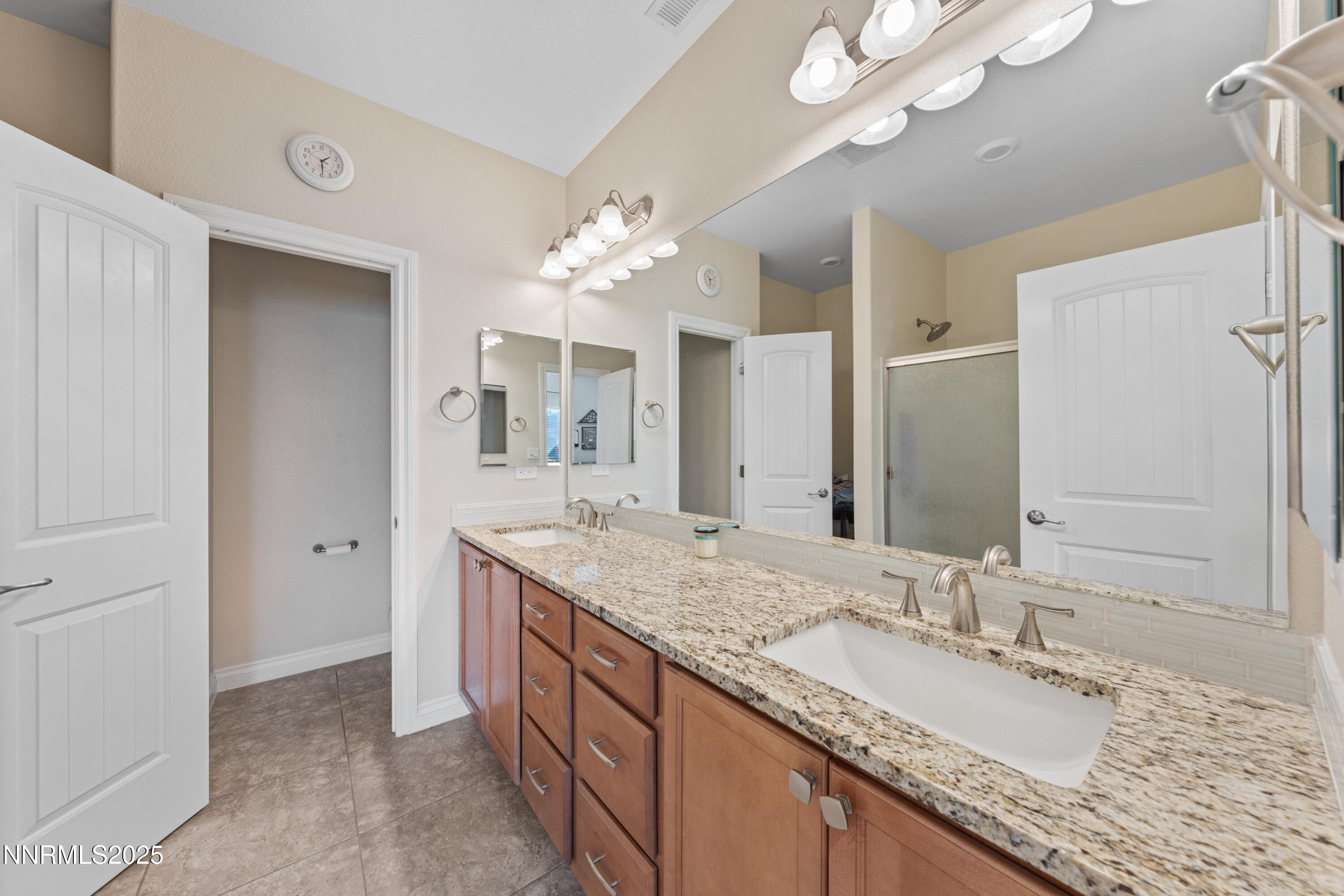 18520 Silverbell Court Reno, NV 89508 - Photo 37 of 60 a bathroom with a granite countertop double vanity sink and a mirror