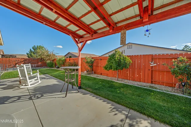 a view of a patio with couches and table under an umbrella