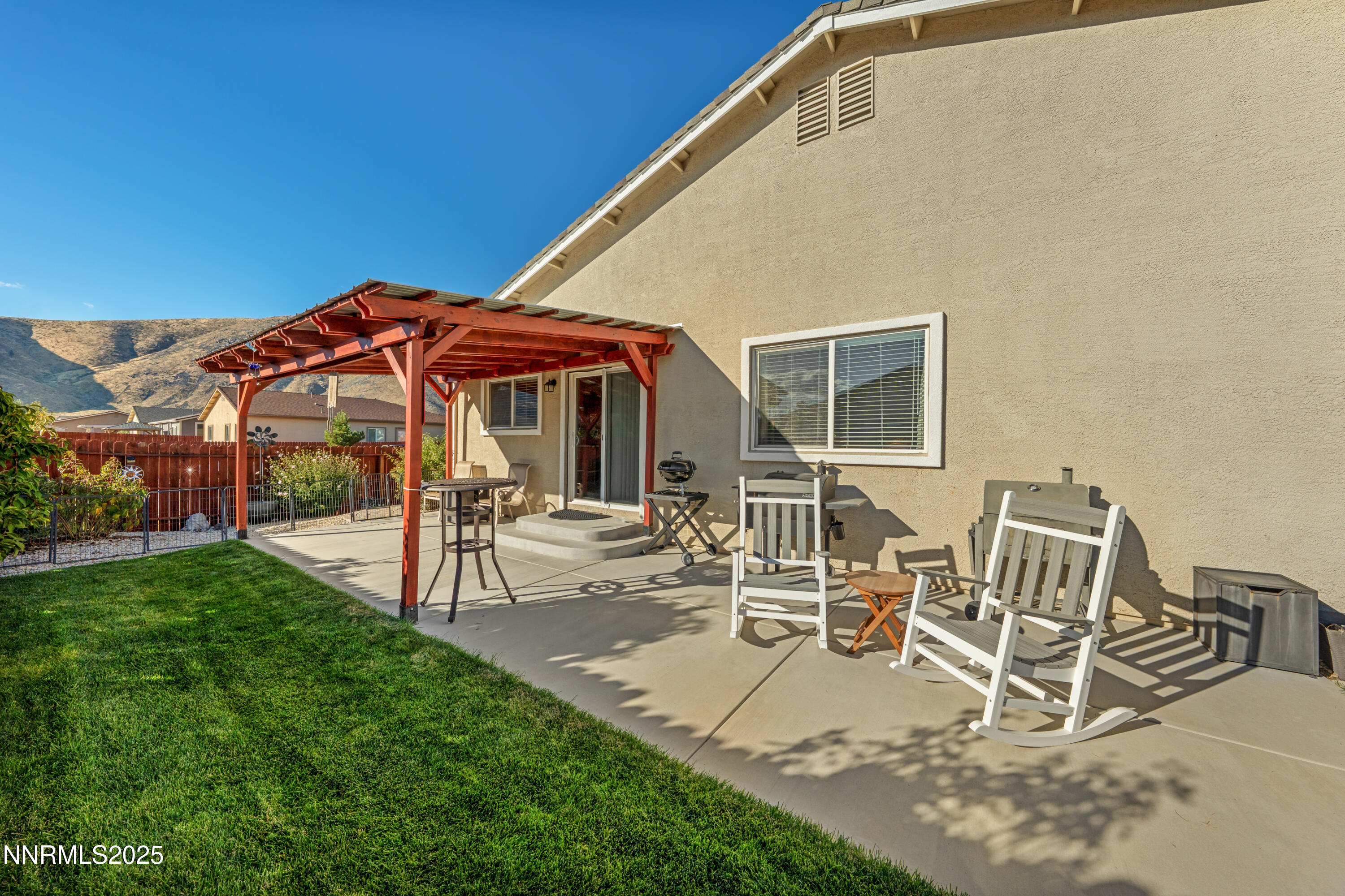 18520 Silverbell Court Reno, NV 89508 - Photo 47 of 60 a view of a patio with table and chairs under an umbrella