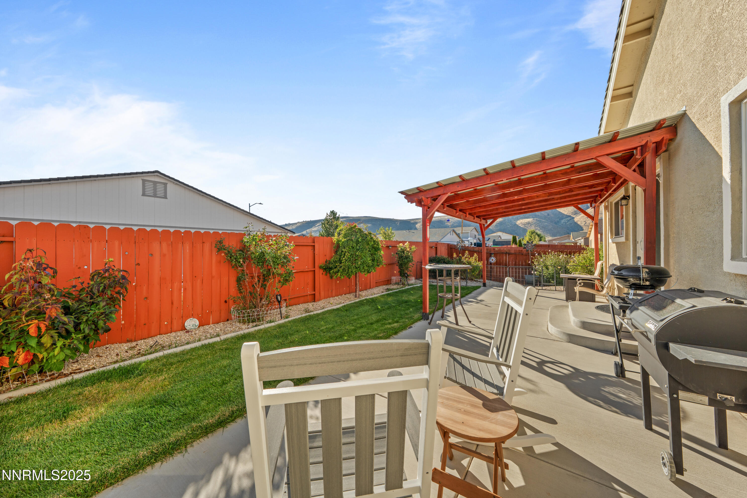 18520 Silverbell Court Reno, NV 89508 - Photo 50 of 60 a view of a patio with couches and table under an umbrella
