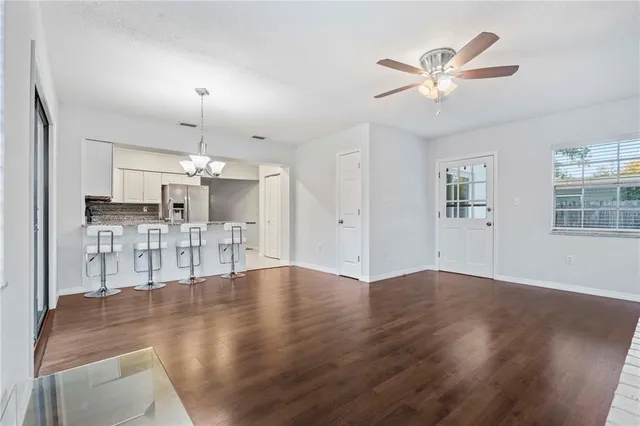a view of a kitchen with wooden floor and a ceiling fan