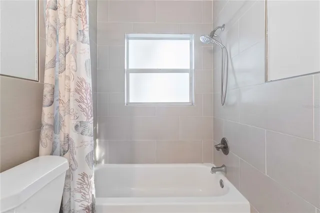 a bathroom with a bathtub and shower