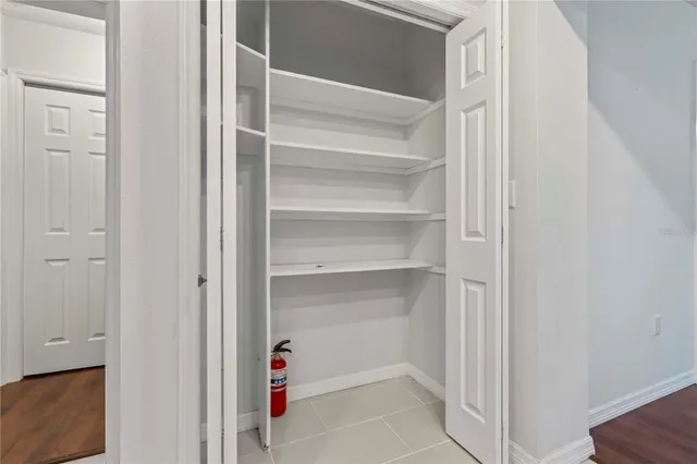 a view of walk in closet with empty racks