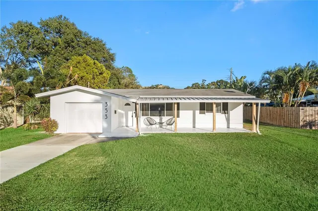 a front view of a house with a garden and yard