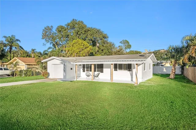 a front view of a house with a garden and yard