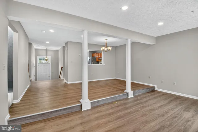 a view of a hallway with wooden floor