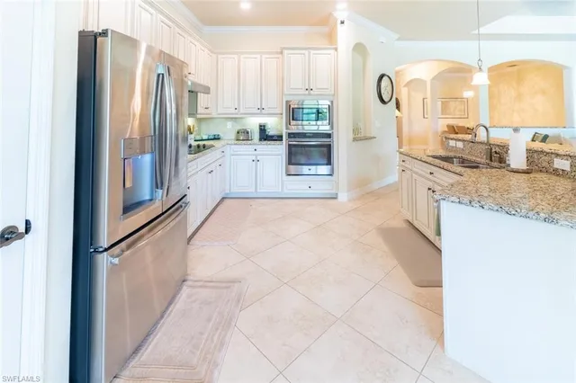 a kitchen with stainless steel appliances granite countertop a refrigerator and a sink