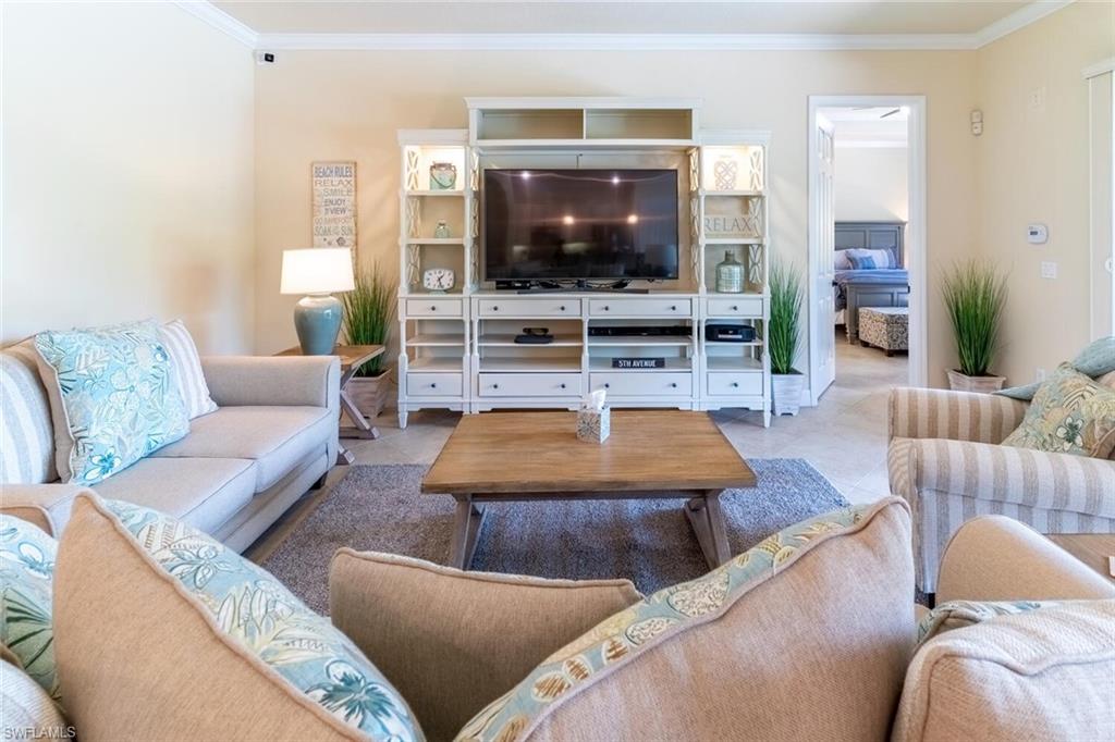 9372 Vercelli Court Naples, FL 34113 - Photo 15 of 50 a living room with furniture and a flat screen tv