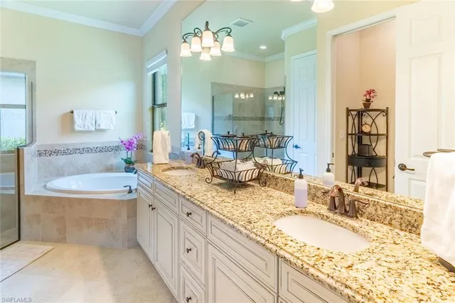 a bathroom with a granite countertop double vanity sink and a mirror