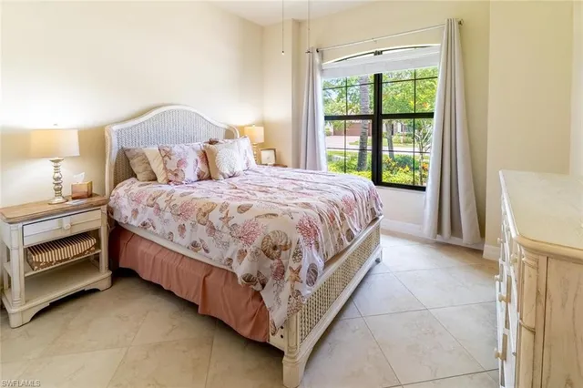 a bed room with a bed and a window