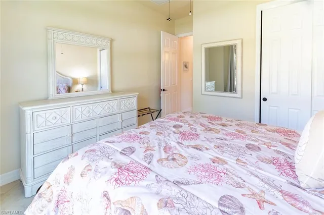 a bedroom with a bed and a mirror on dresser