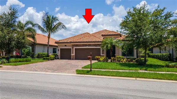 a front view of a house with a yard and potted plants