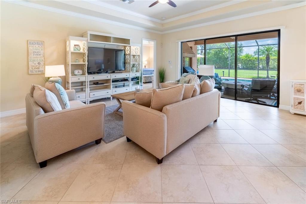 9372 Vercelli Court Naples, FL 34113 - Photo 7 of 50 a living room with furniture and a flat screen tv